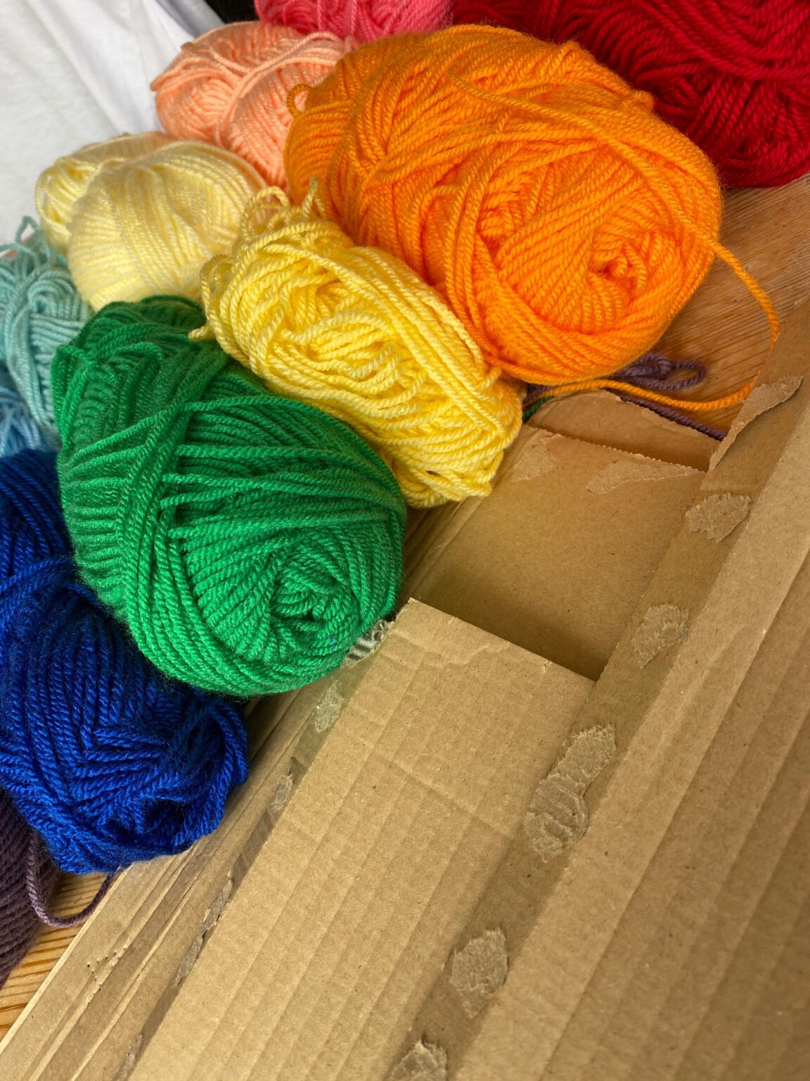 Bright rainbow yarn and cardboard all ready to go.